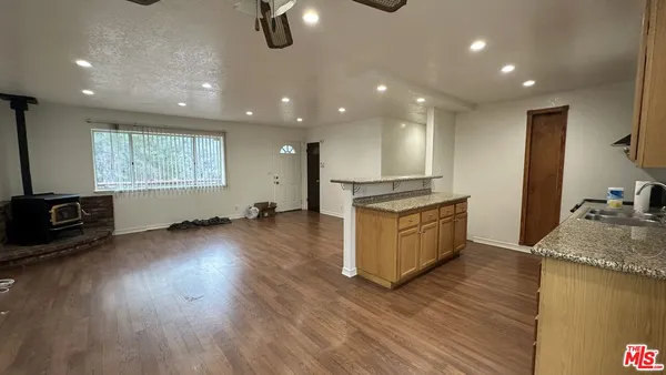 a kitchen with stainless steel appliances granite countertop a stove a sink and a refrigerator