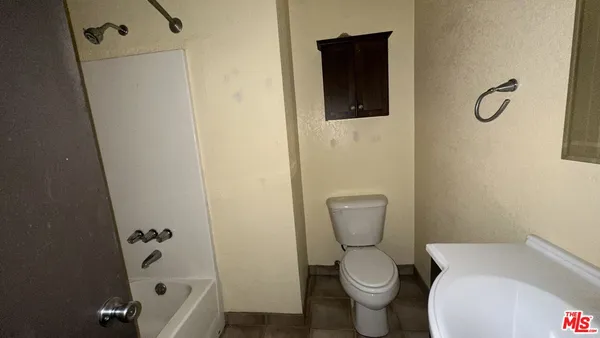 a white toilet sitting next to a bathroom sink