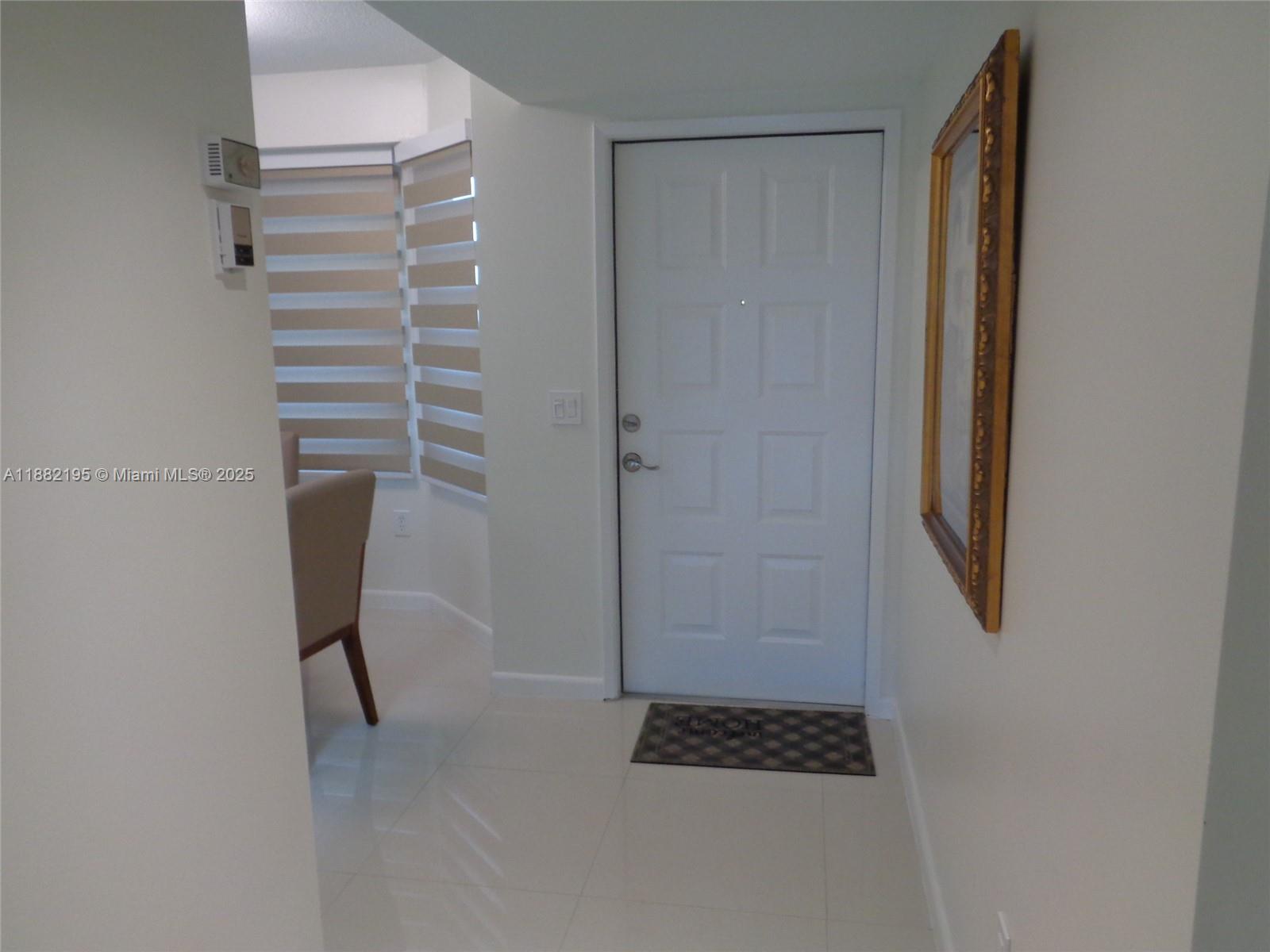 701 Southwest 141st Avenue, Unit 412R Pembroke Pines, FL 33027 - Photo 11 of 52 a view of walk in closet with clothes and shoes