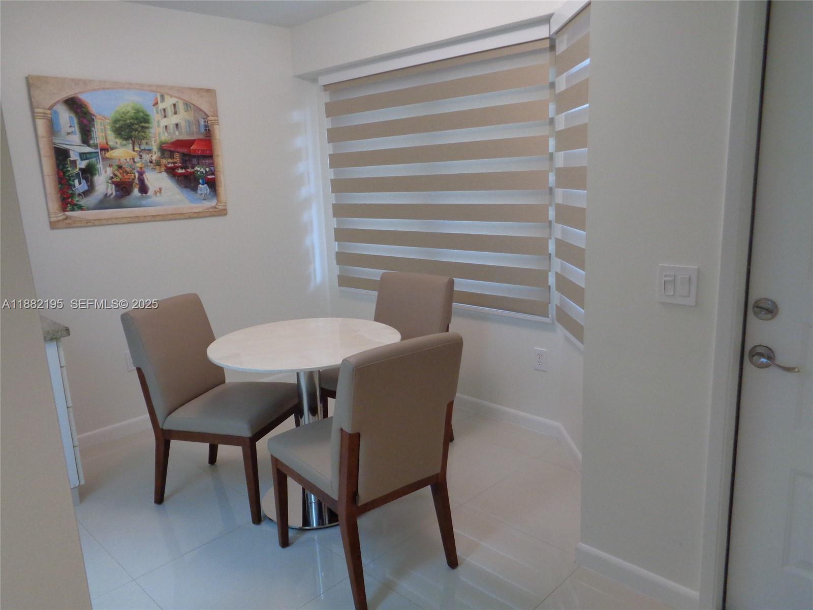 701 Southwest 141st Avenue, Unit 412R Pembroke Pines, FL 33027 - Photo 12 of 52 a dining room with furniture and a window