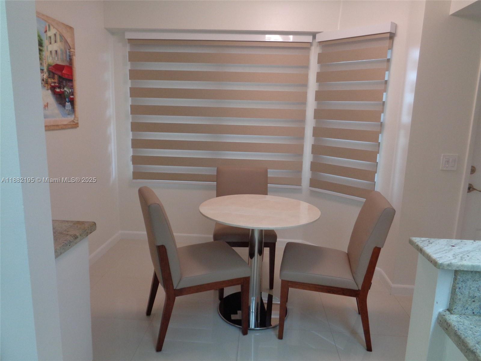 701 Southwest 141st Avenue, Unit 412R Pembroke Pines, FL 33027 - Photo 13 of 52 a view of a dining room with furniture and wooden floor