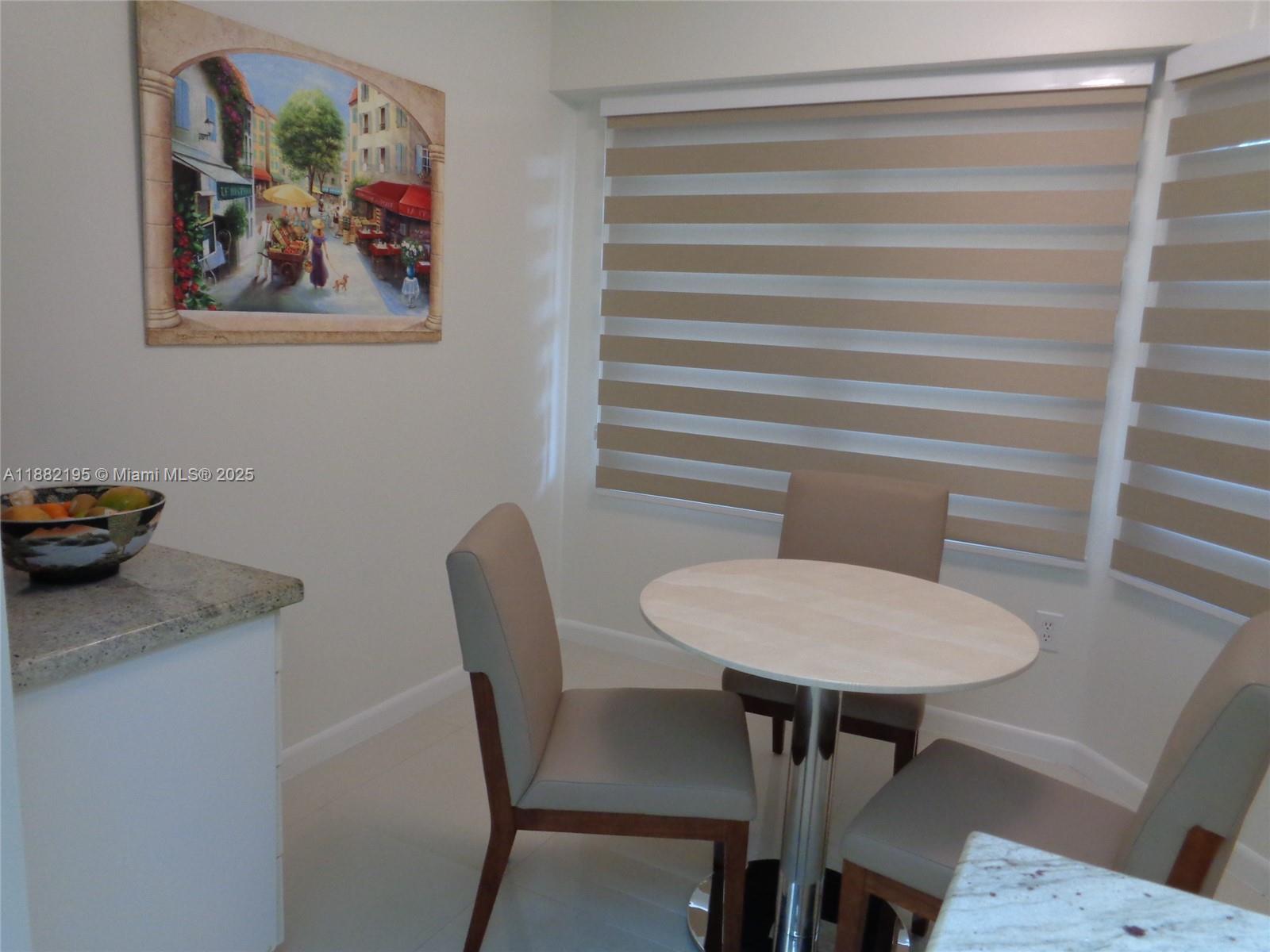 701 Southwest 141st Avenue, Unit 412R Pembroke Pines, FL 33027 - Photo 14 of 52 a view of a dining room with furniture and wooden floor