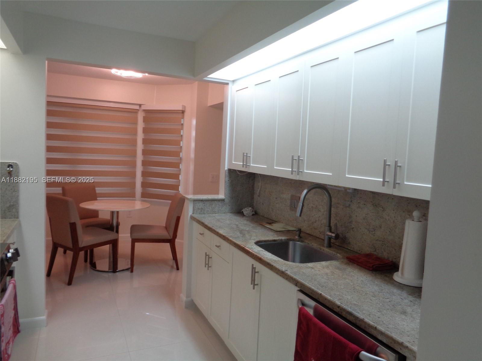 701 Southwest 141st Avenue, Unit 412R Pembroke Pines, FL 33027 - Photo 19 of 52 a kitchen with a sink cabinets and window