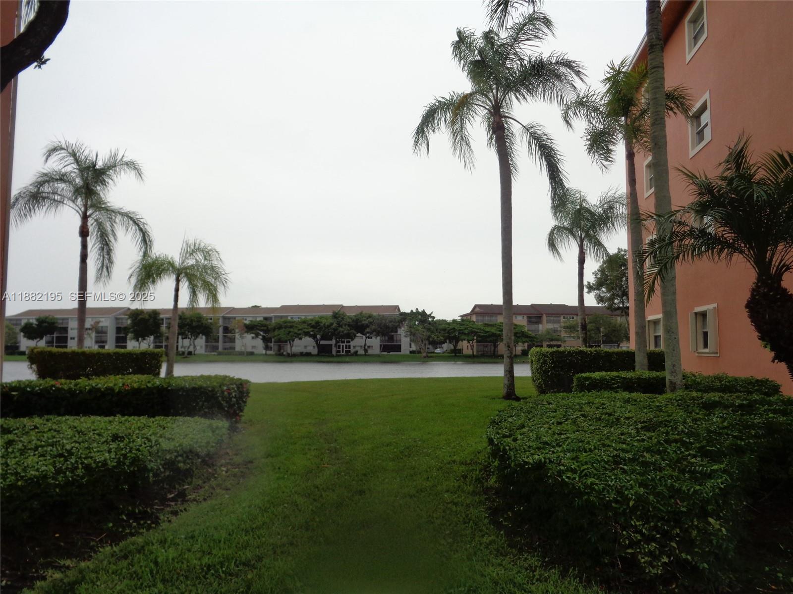 701 Southwest 141st Avenue, Unit 412R Pembroke Pines, FL 33027 - Photo 2 of 52 a view of a park and palm trees