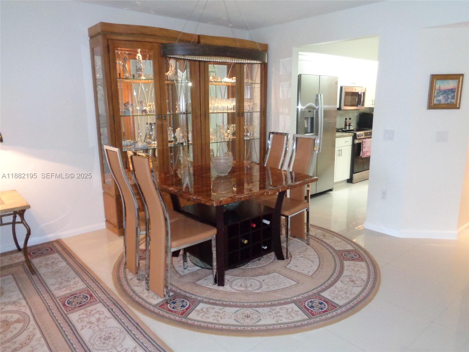 701 Southwest 141st Avenue, Unit 412R Pembroke Pines, FL 33027 - Photo 22 of 52 a view of a dining room with furniture wooden floor and next to a window