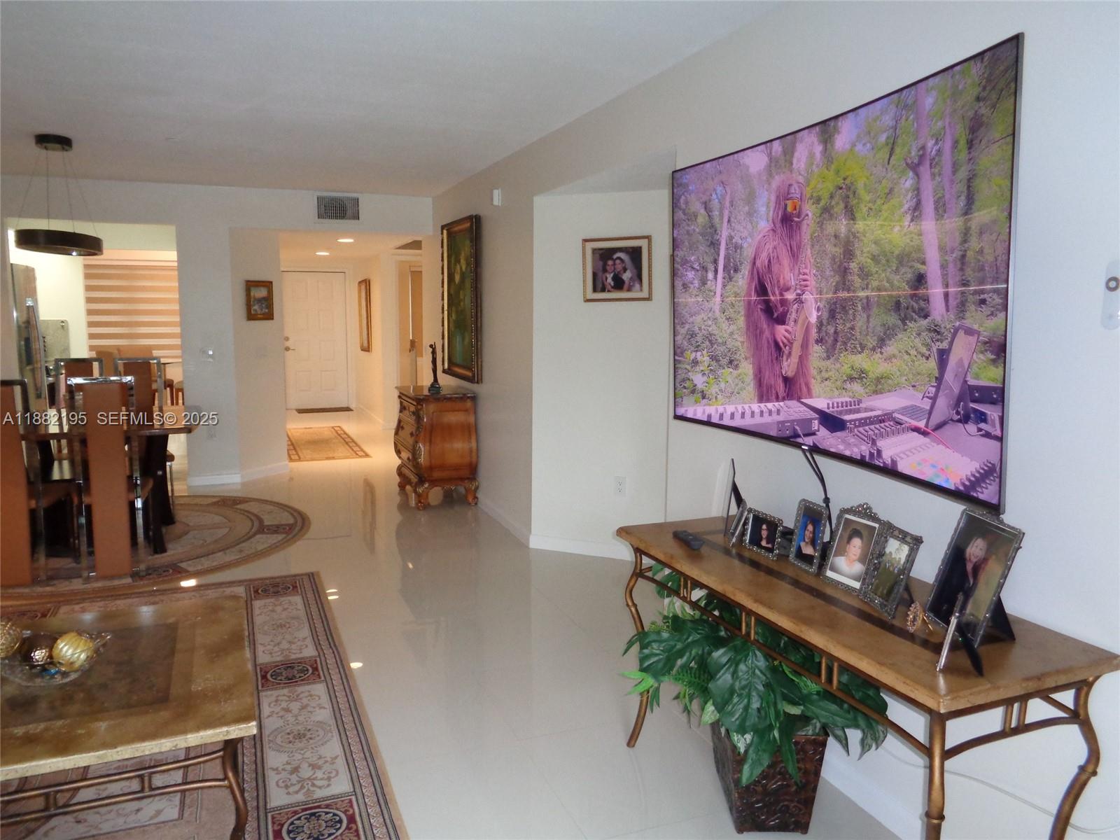 701 Southwest 141st Avenue, Unit 412R Pembroke Pines, FL 33027 - Photo 26 of 52 a room with furniture and wooden floor