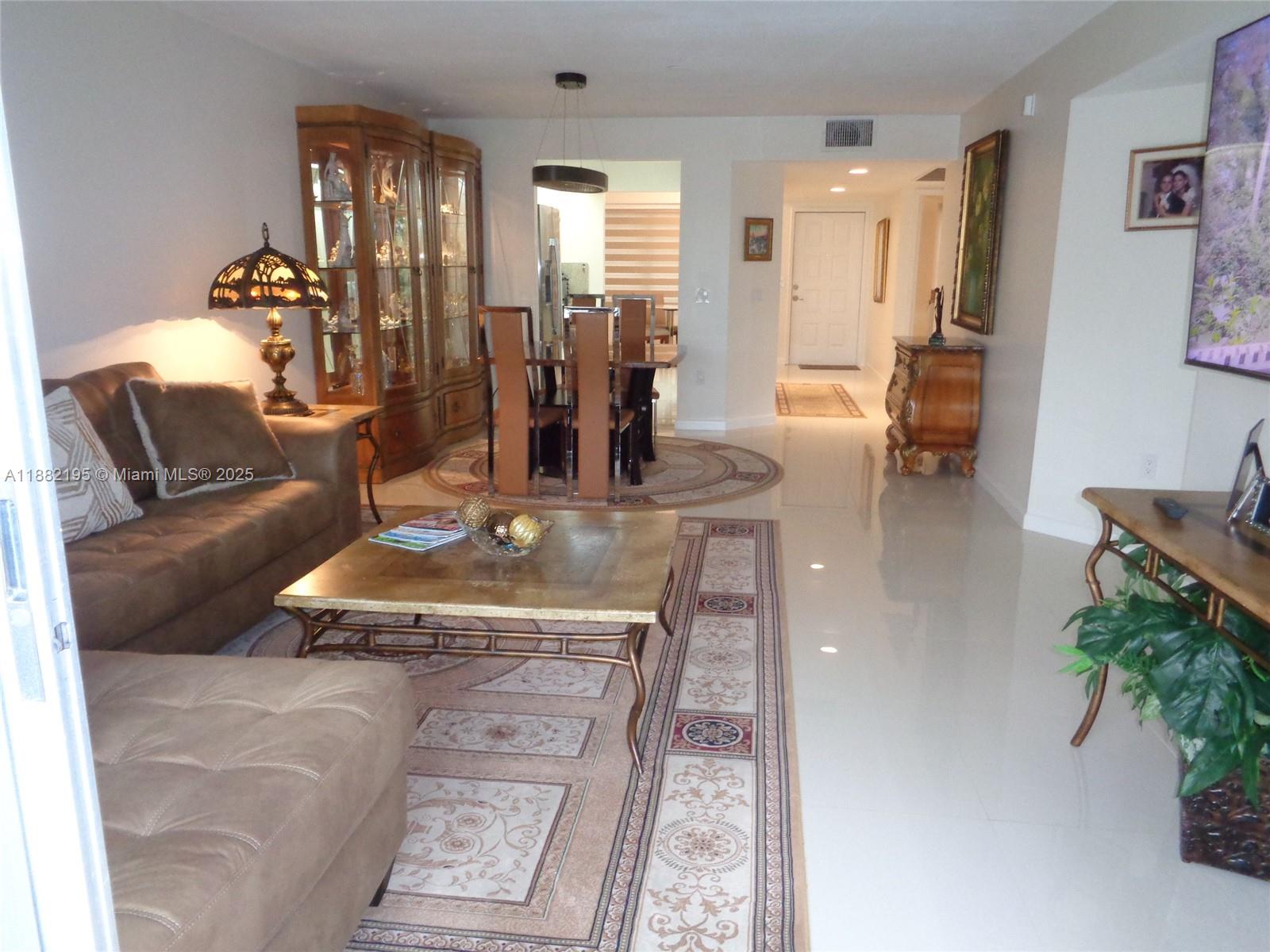 701 Southwest 141st Avenue, Unit 412R Pembroke Pines, FL 33027 - Photo 27 of 52 a living room with furniture and wooden floor