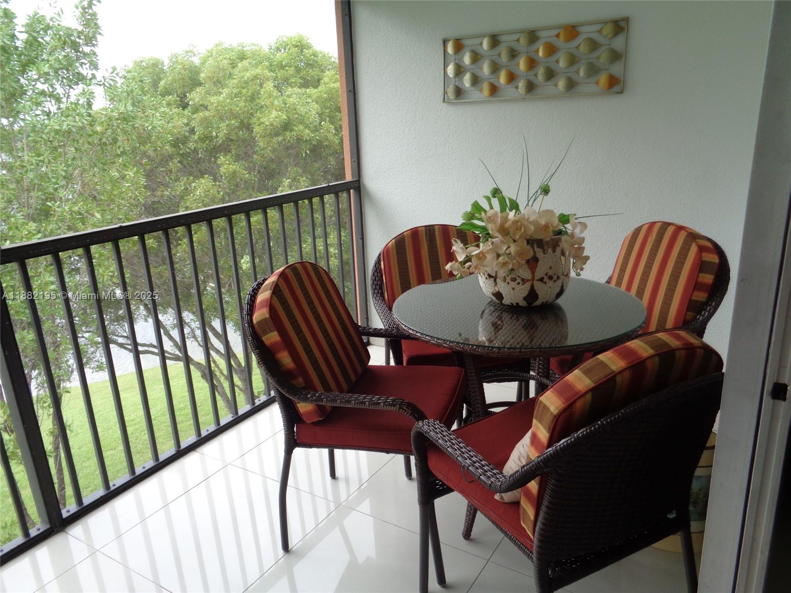701 Southwest 141st Avenue, Unit 412R Pembroke Pines, FL 33027 - Photo 29 of 52 a view of a balcony with a table and chairs