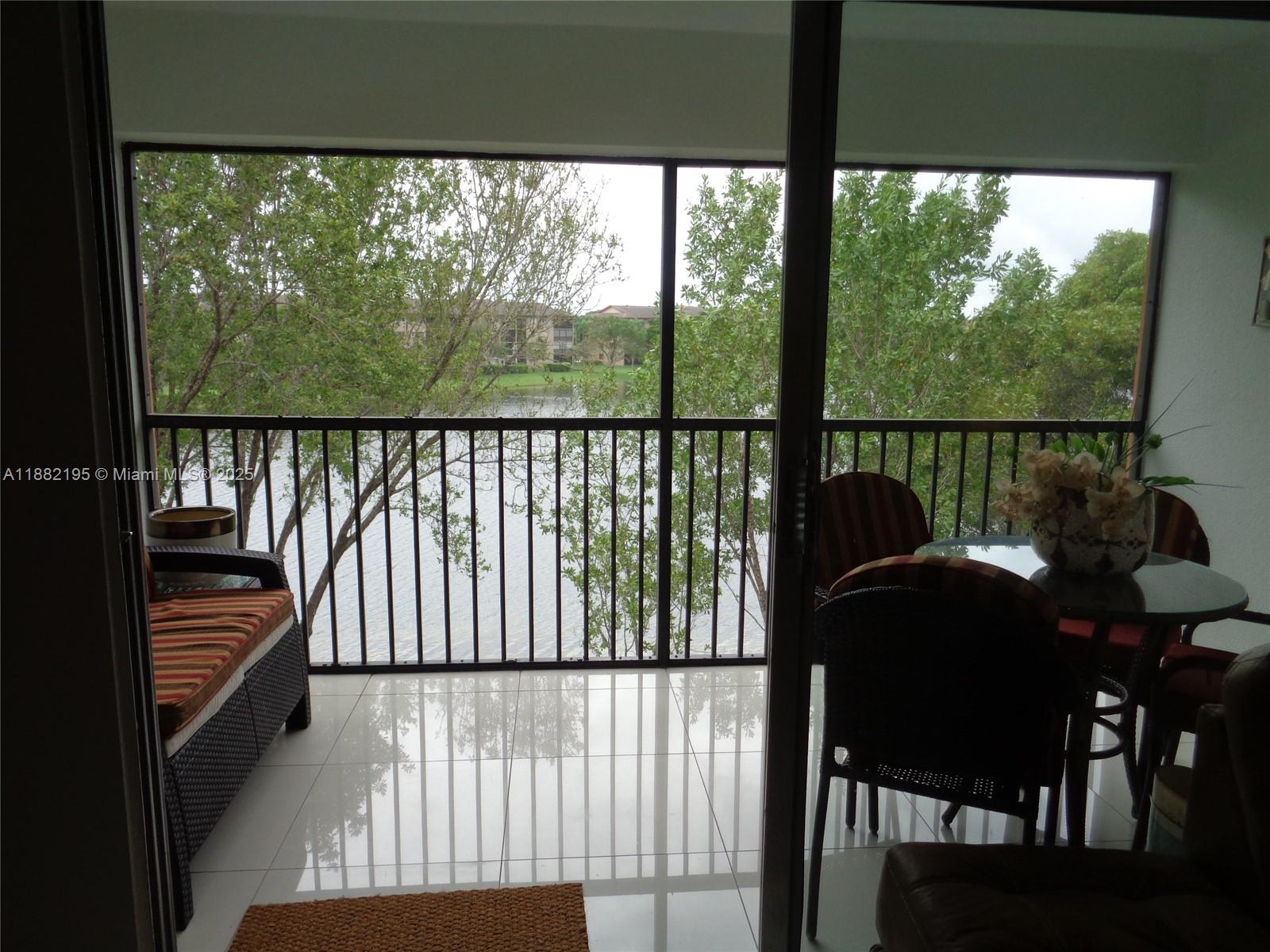 701 Southwest 141st Avenue, Unit 412R Pembroke Pines, FL 33027 - Photo 30 of 52 a view of a chairs and table in patio