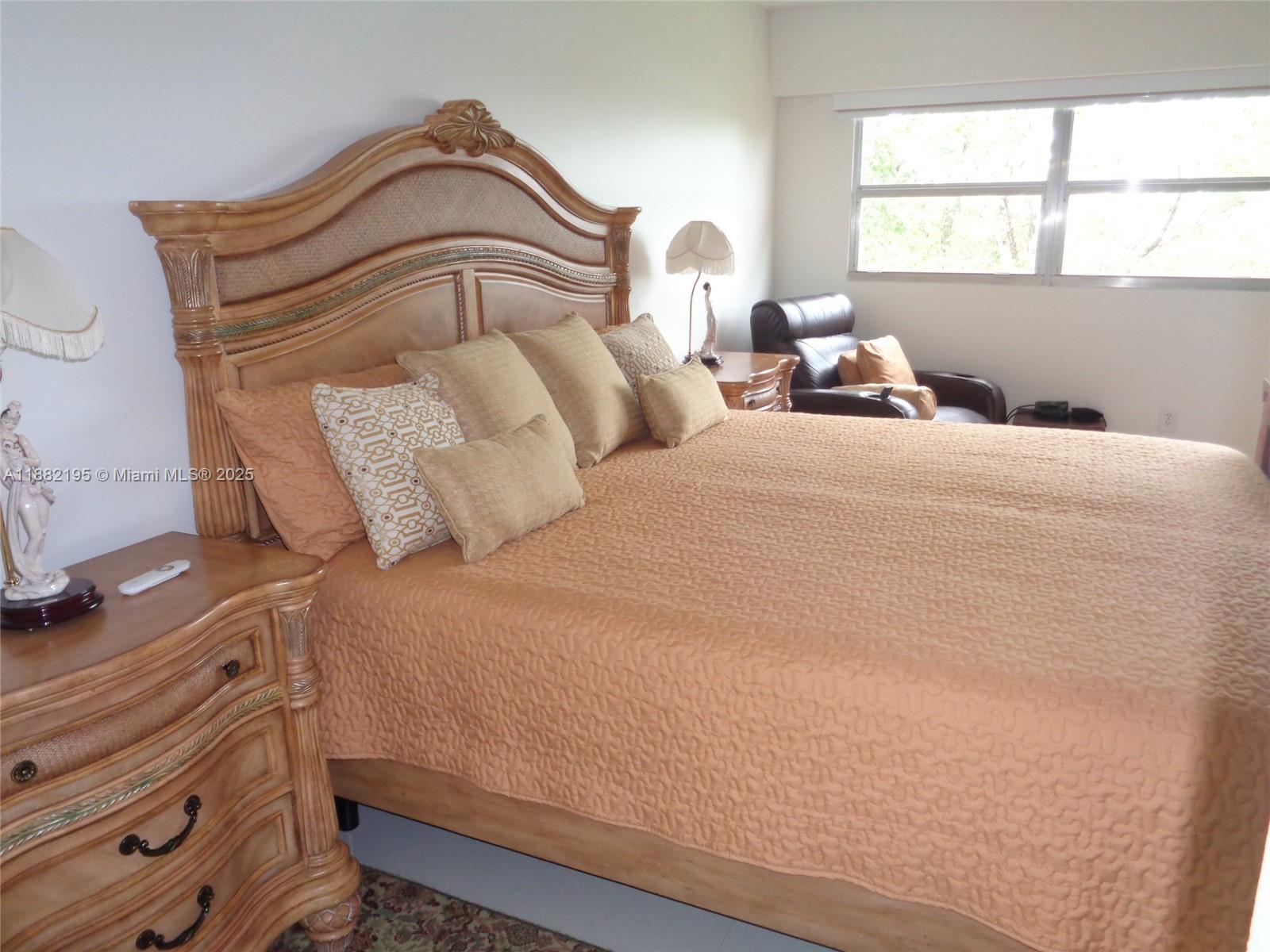 701 Southwest 141st Avenue, Unit 412R Pembroke Pines, FL 33027 - Photo 31 of 52 a bedroom with a bed and window