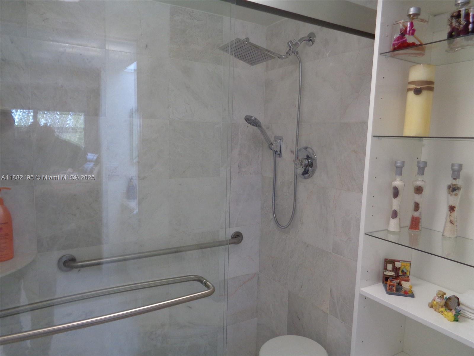 701 Southwest 141st Avenue, Unit 412R Pembroke Pines, FL 33027 - Photo 33 of 52 a bathroom with a shower