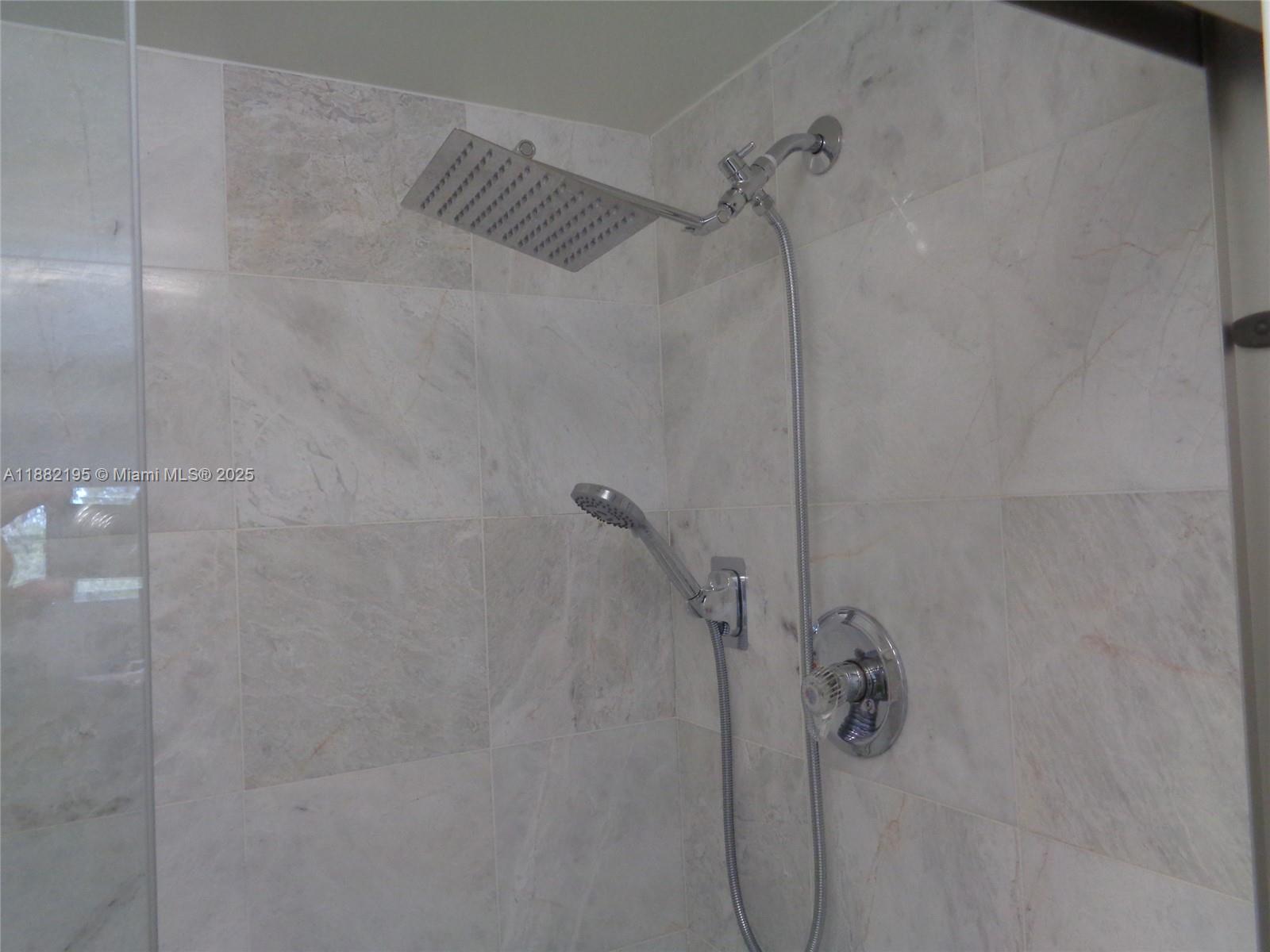 701 Southwest 141st Avenue, Unit 412R Pembroke Pines, FL 33027 - Photo 34 of 52 a bathroom with a shower