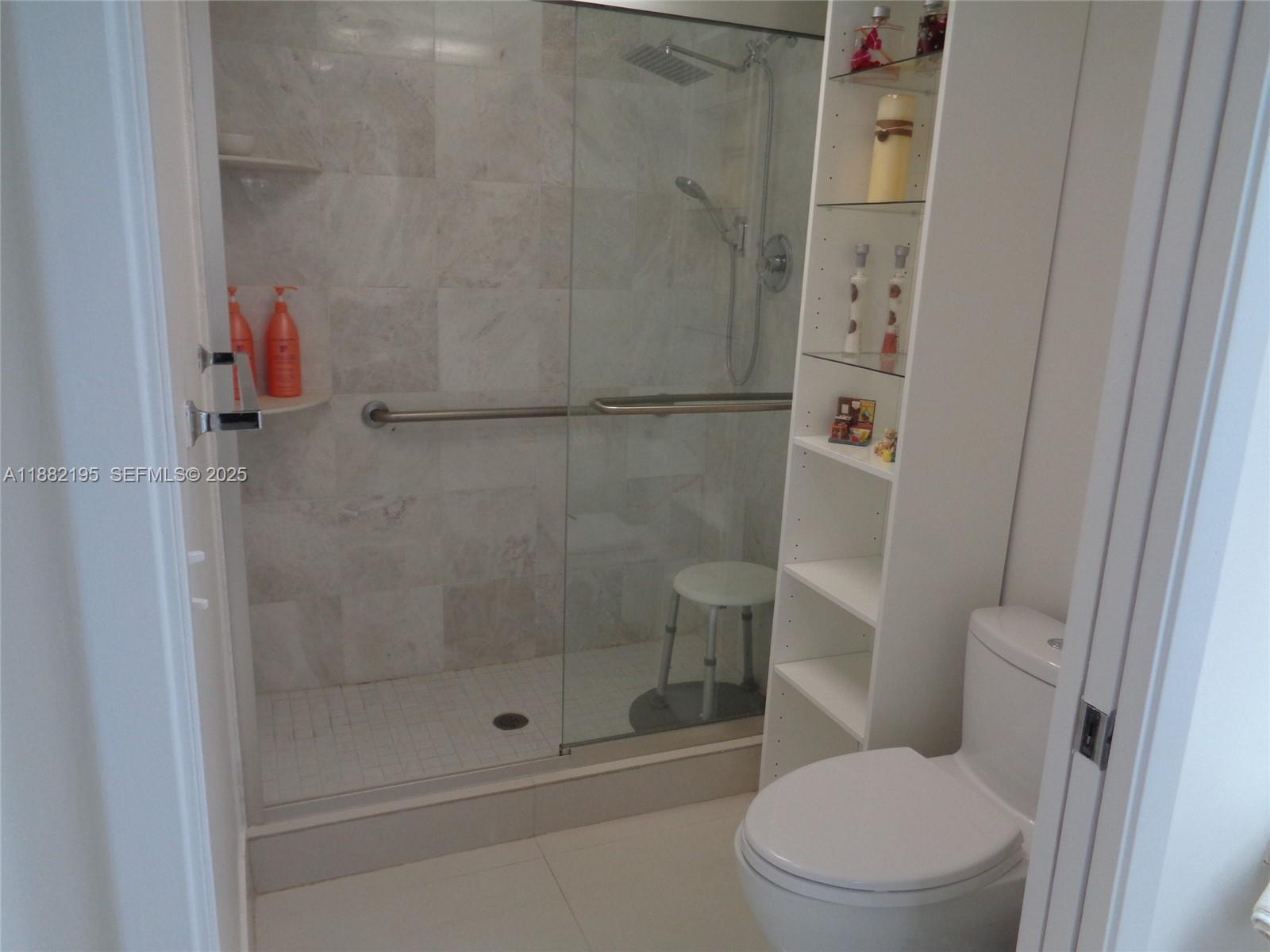 701 Southwest 141st Avenue, Unit 412R Pembroke Pines, FL 33027 - Photo 36 of 52 a bathroom with a shower and toilet