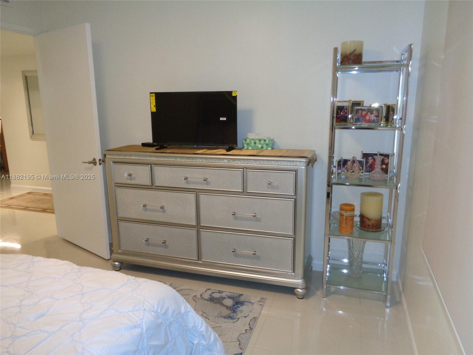 701 Southwest 141st Avenue, Unit 412R Pembroke Pines, FL 33027 - Photo 43 of 52 a bedroom with a bed and a cabinets