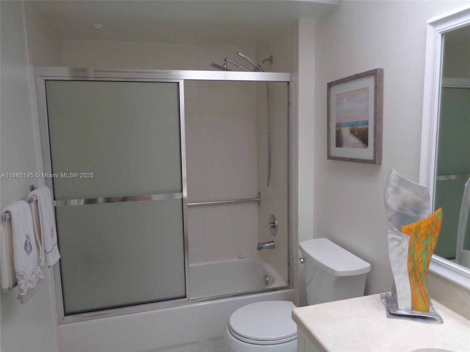 701 Southwest 141st Avenue, Unit 412R Pembroke Pines, FL 33027 - Photo 45 of 52 a bathroom with a toilet and a shower