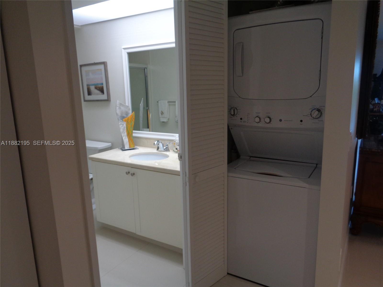 701 Southwest 141st Avenue, Unit 412R Pembroke Pines, FL 33027 - Photo 47 of 52 a bathroom with a sink and mirror