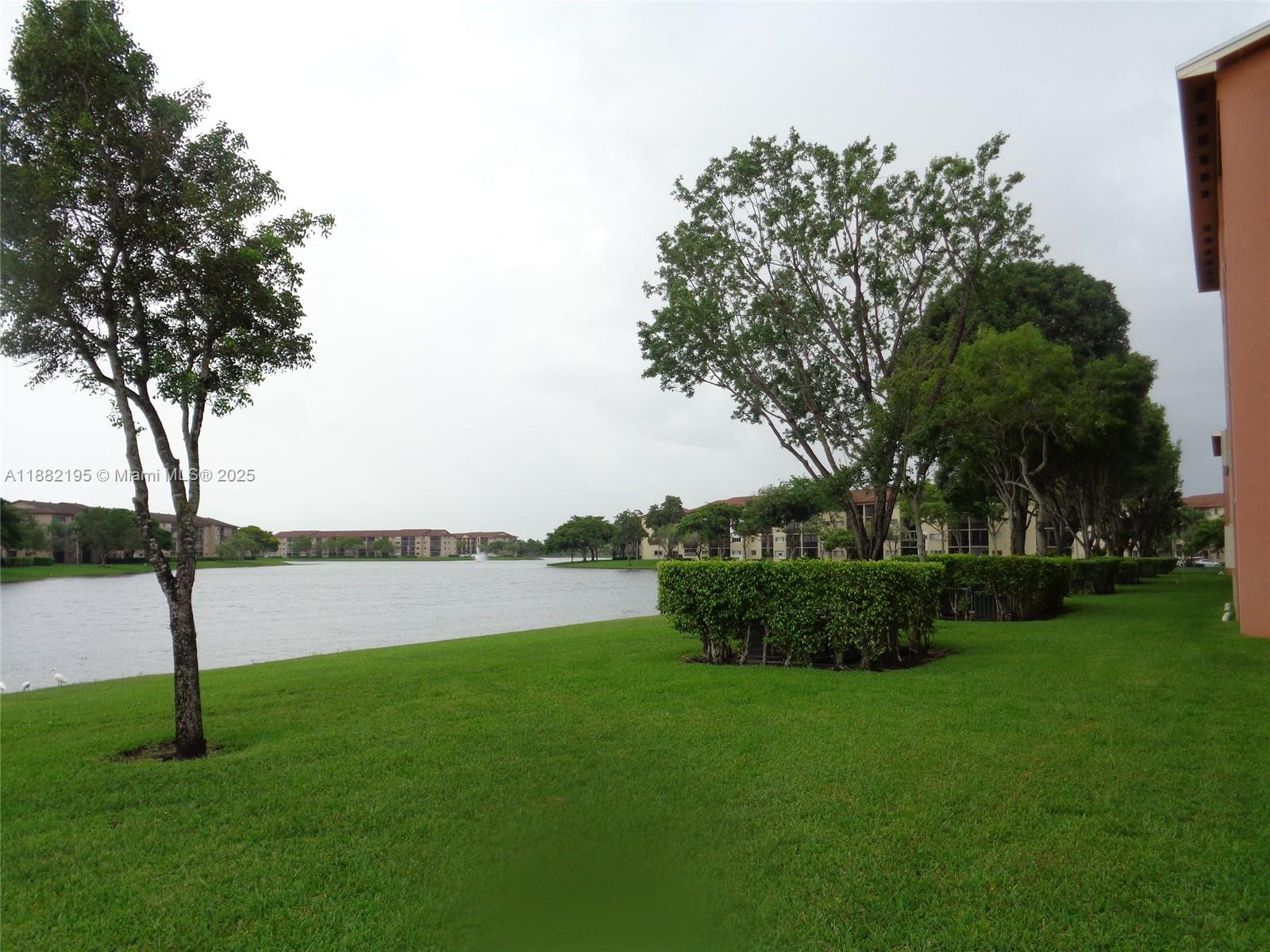 701 Southwest 141st Avenue, Unit 412R Pembroke Pines, FL 33027 - Photo 50 of 52 a view of a garden with lake