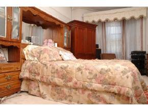 896 Eastern Parkway Brooklyn, NY 11213 - Photo 4 of 8 a bed sitting in a spacious bedroom next to a window