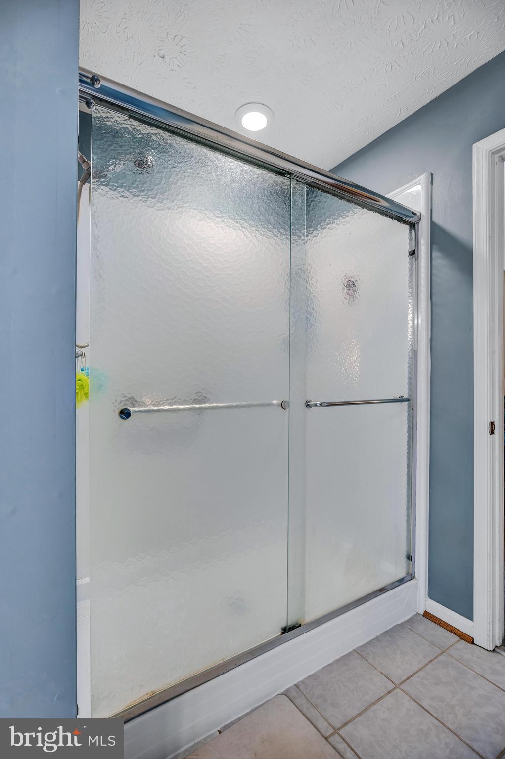 11535 Honeysuckle Court Issue, MD 20645 - Photo 12 of 21 a bathroom with a glass shower door
