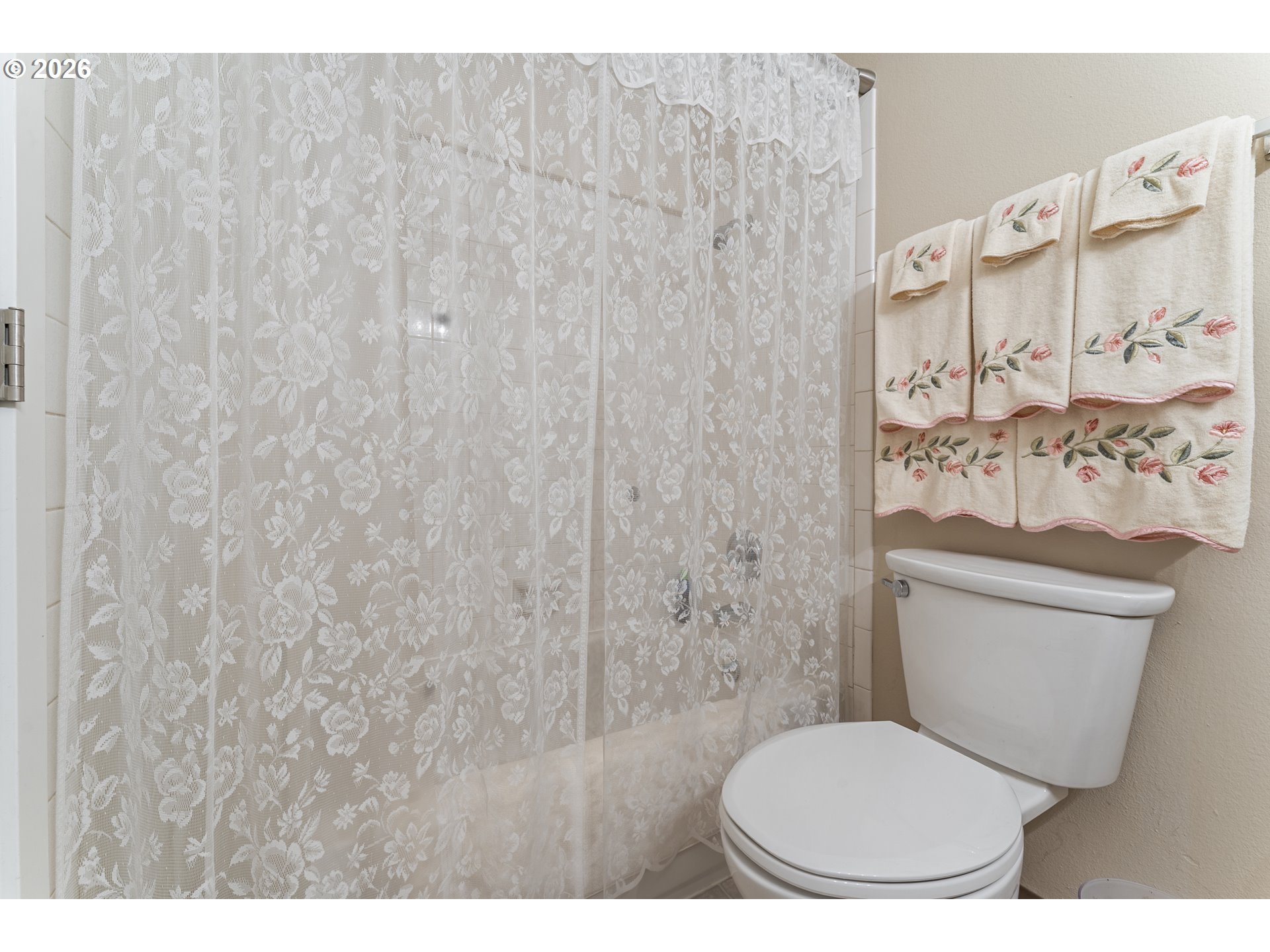 11341 Southwest Springwood Drive Portland, OR 97223 - Photo 23 of 26 a bathroom with a toilet and a shower curtain