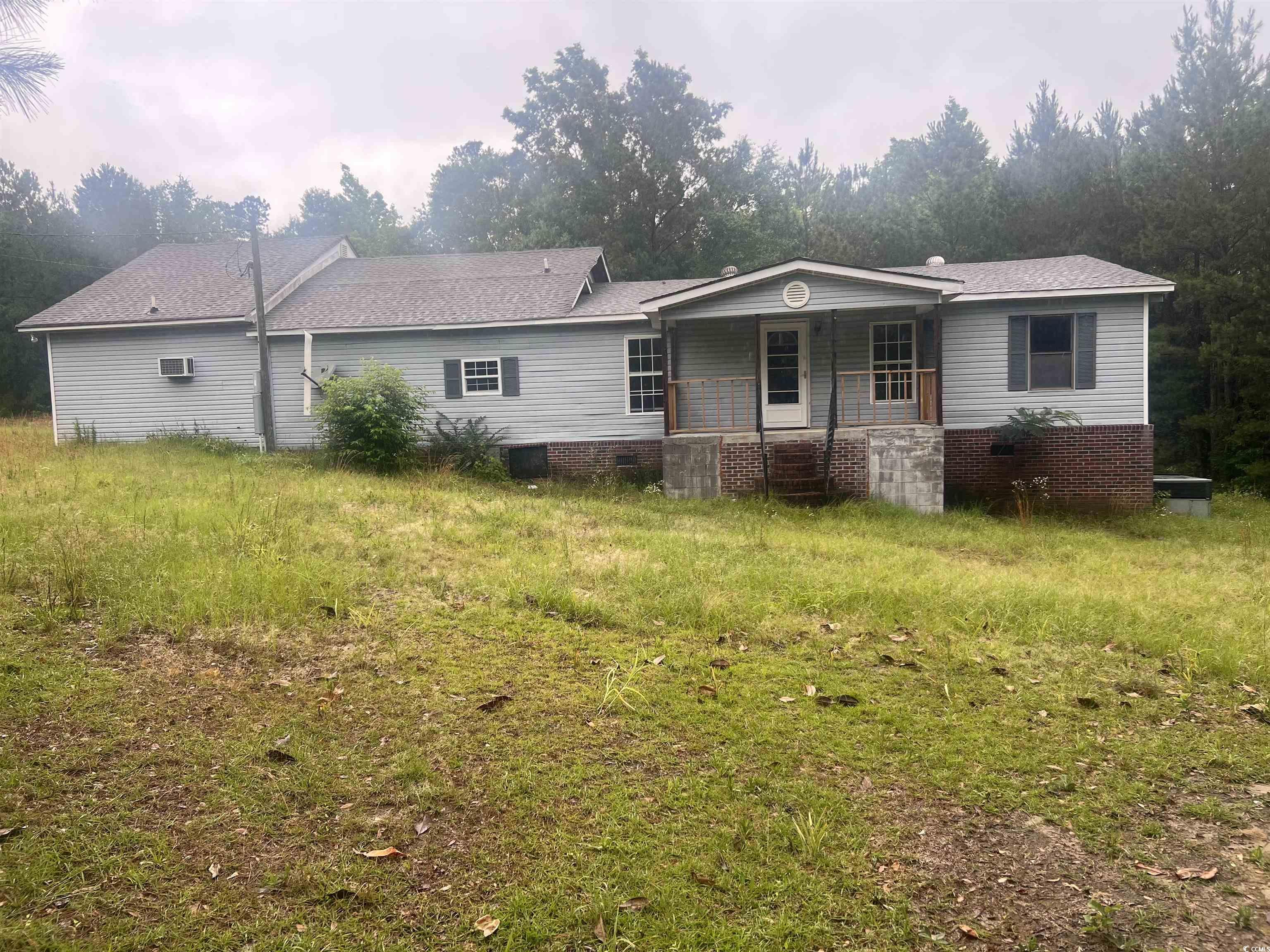 Back of house featuring covered porch, crawl space