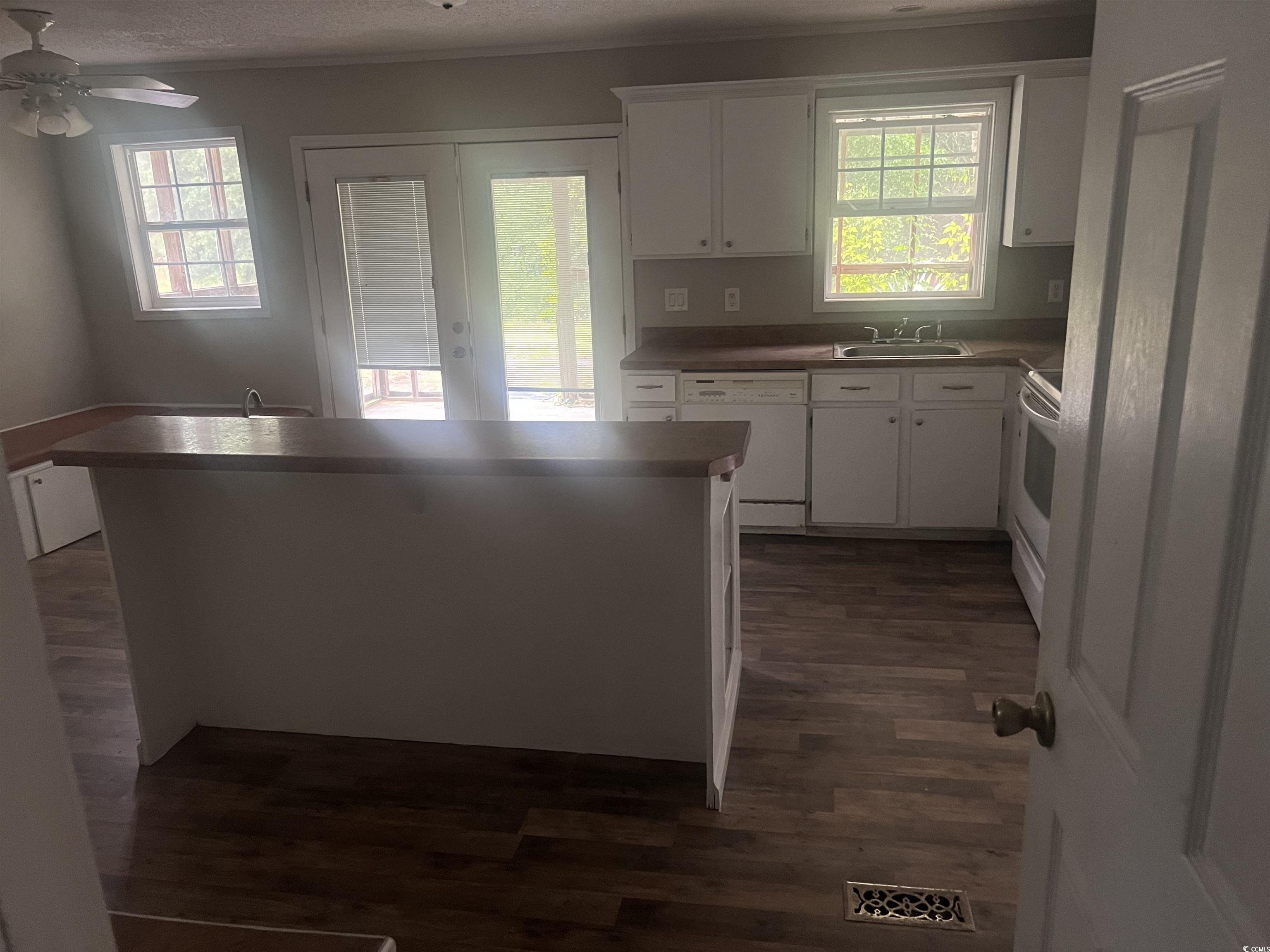 4675 Brailsford Circle Rembert, SC 29128 - Photo 6 of 20 Kitchen featuring white appliances, dark wood-styl
