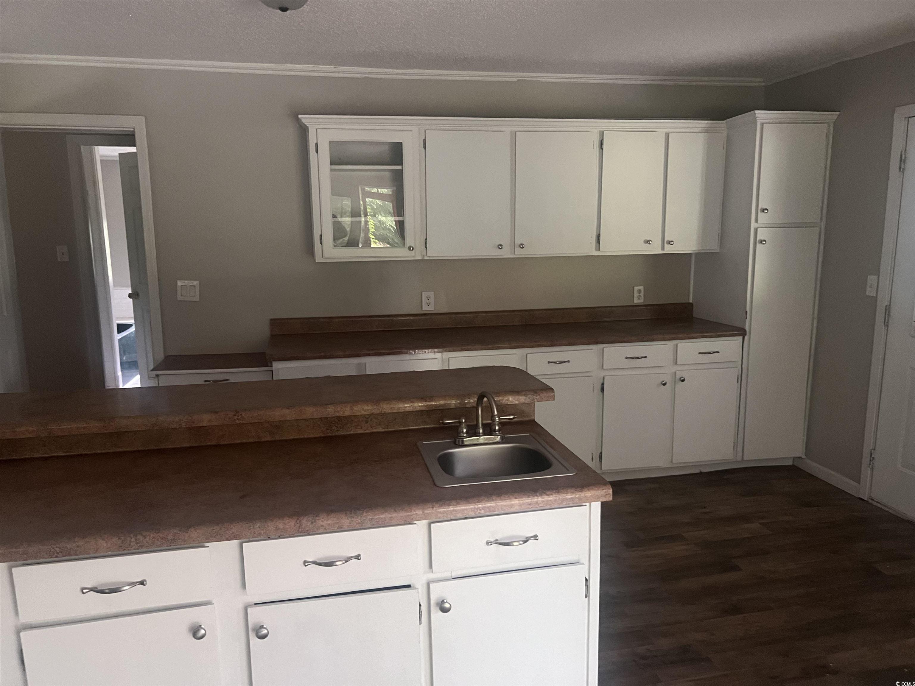 4675 Brailsford Circle Rembert, SC 29128 - Photo 9 of 20 Kitchen with a sink, ornamental molding, white cab