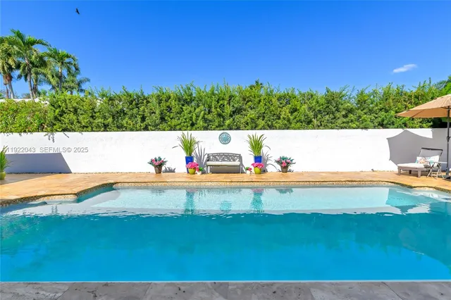 a view of an outdoor pool and outdoor seating