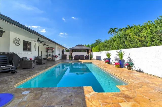 a swimming pool with outdoor seating