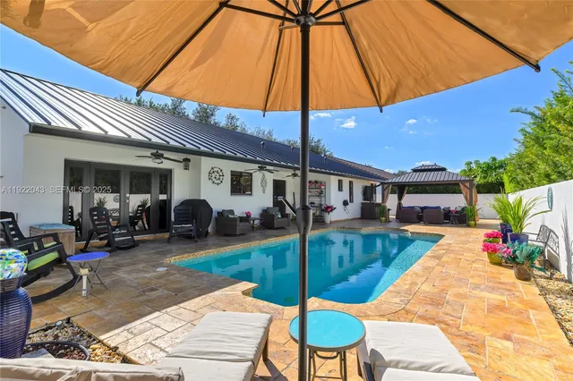 a bedroom with furniture and a large window
