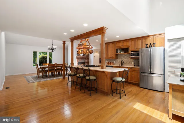 a kitchen with stainless steel appliances granite countertop a stove and a wooden floors