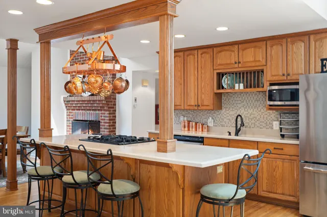 a kitchen with stainless steel appliances a stove a sink and a refrigerator