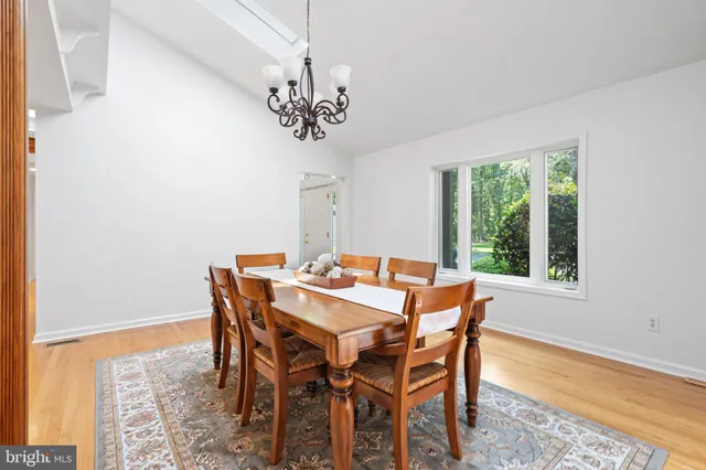 a bathroom with a toilet a sink a tub and a mirror