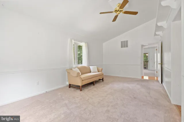 an empty room with a ceiling fan and window