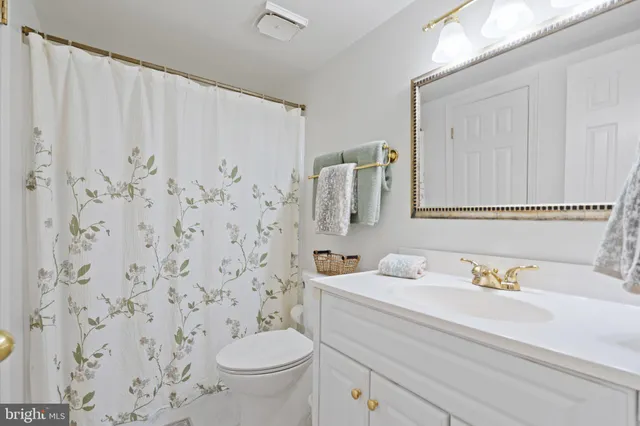 a bedroom with two beds and wooden floor