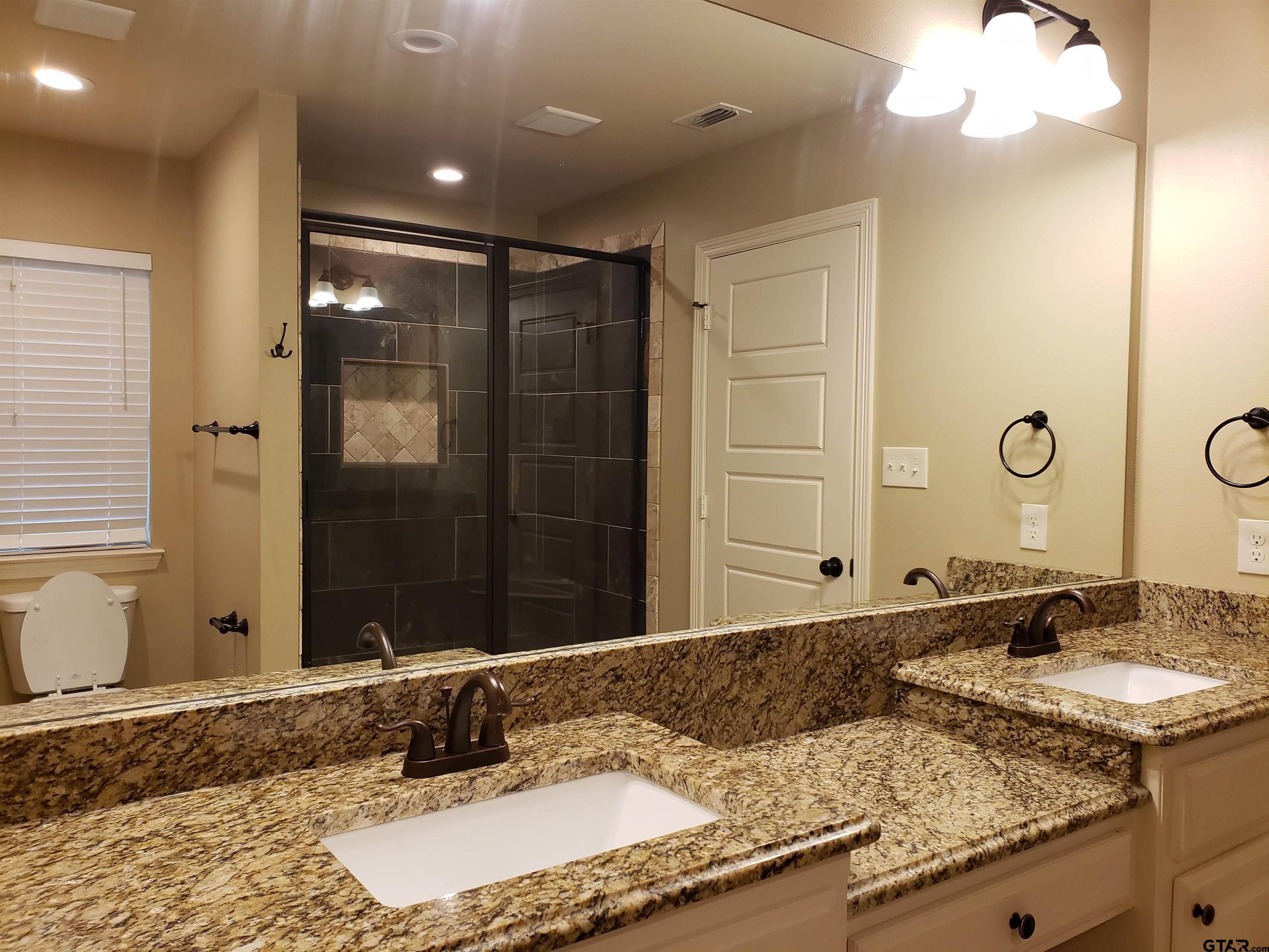 3700 Old Omen Road Tyler, TX 75707 - Photo 15 of 21 a bathroom with a granite countertop sink and a mirror
