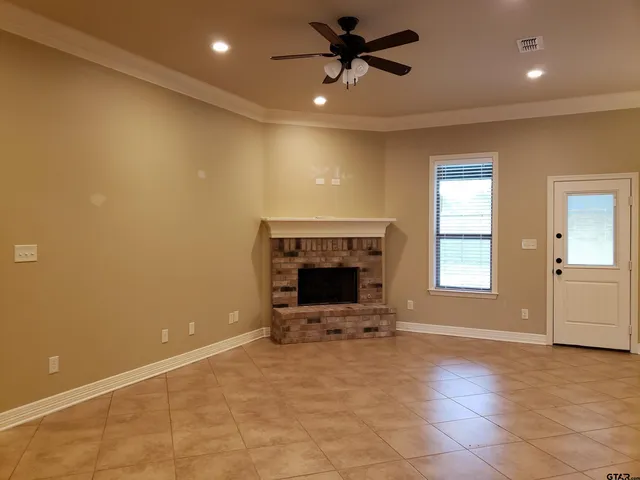 a view of a livingroom with a fireplace and window