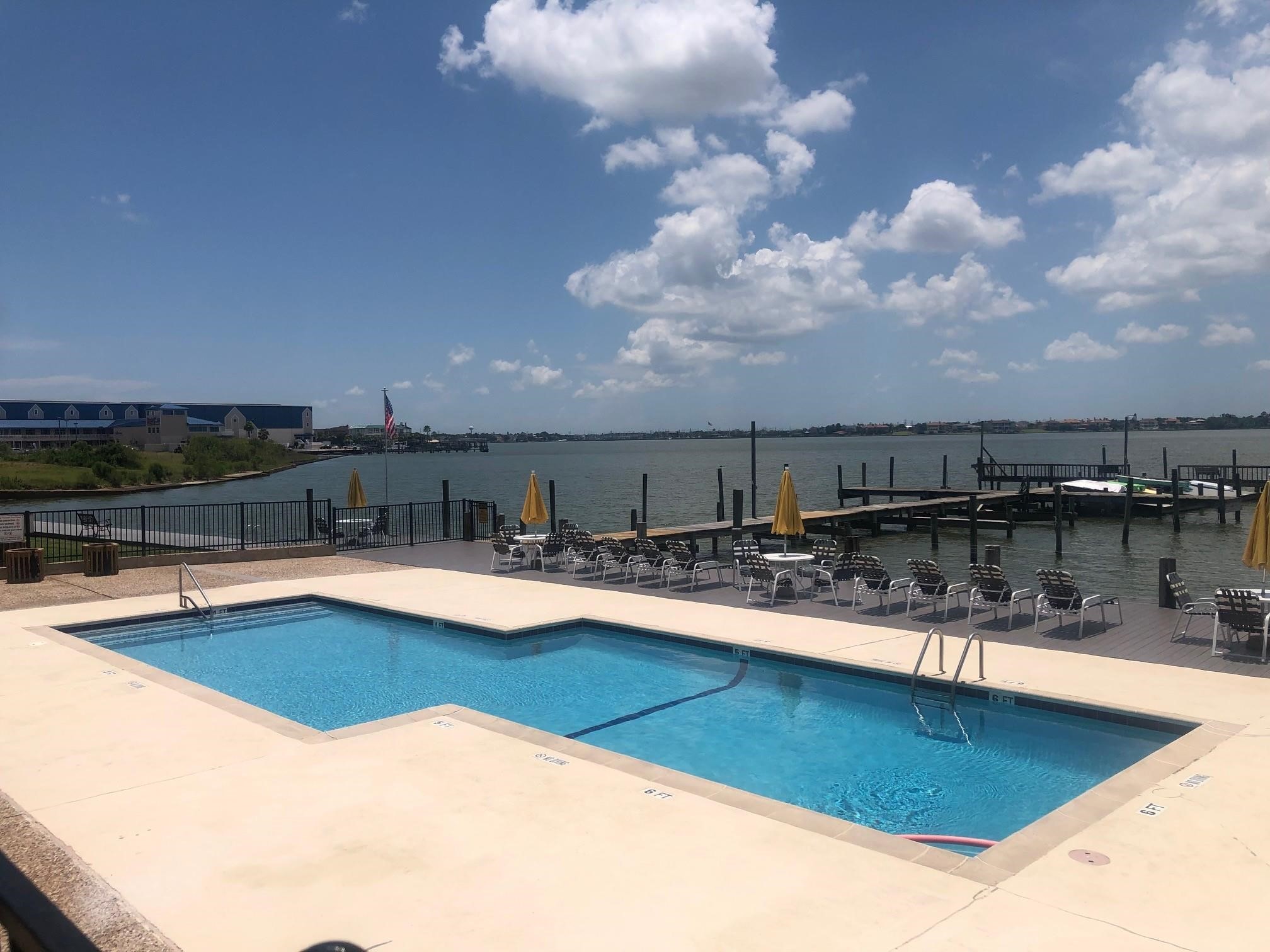 3535 NASA Road 1, Unit 49 Seabrook, TX 77586 - Photo 1 of 17 a view of a swimming pool with outdoor seating