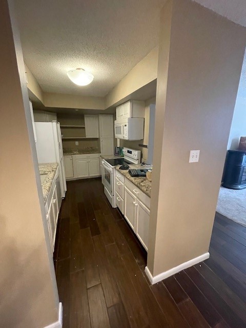 3535 NASA Road 1, Unit 49 Seabrook, TX 77586 - Photo 7 of 17 a kitchen with sink refrigerator and wooden floor