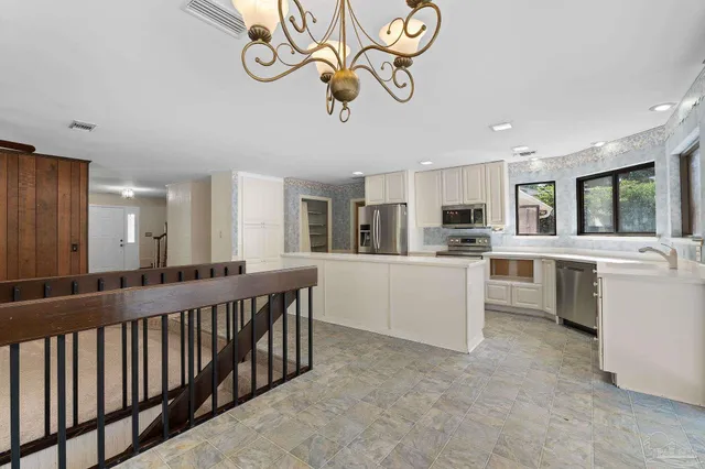 a kitchen with stainless steel appliances a refrigerator a stove and a sink