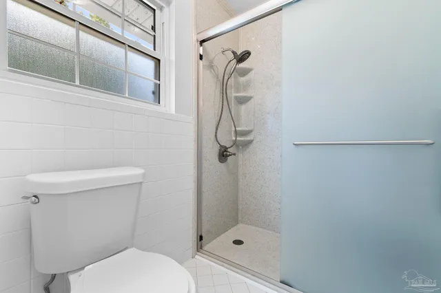a spacious bathroom with a granite countertop sink mirror and a