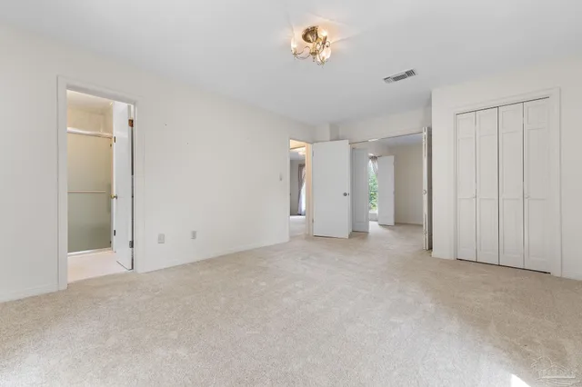 a bathroom with a granite countertop sink mirror and cabinets
