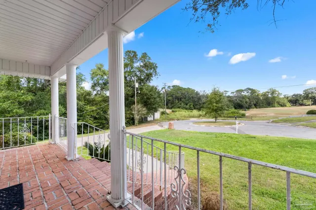 a view of a balcony with yard