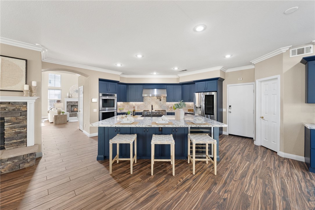 31465 Inverness Court Temecula, CA 92591 - Photo 19 of 75 Designed for entertaining, the spacious kitchen opens effortlessly to the surrounding living areas and offers abundant counter and gathering space | Professionally Staged