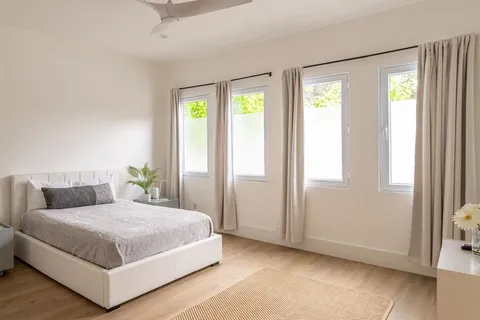 a bedroom with a large bed and a window