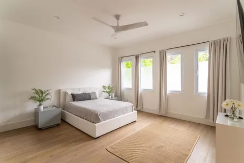 a spacious bedroom with a bed and a window