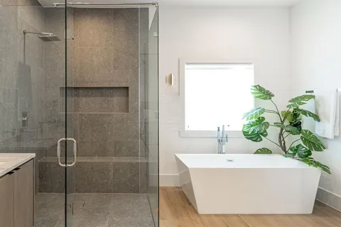 a bathroom with a bathtub and shower