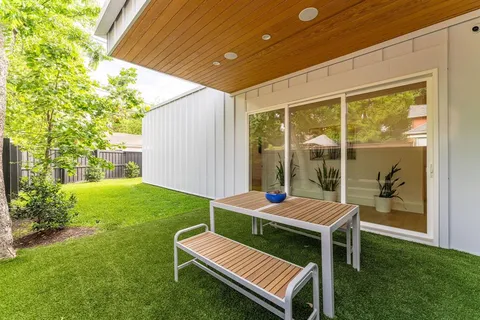 a outdoor sitting area with a table and chairs