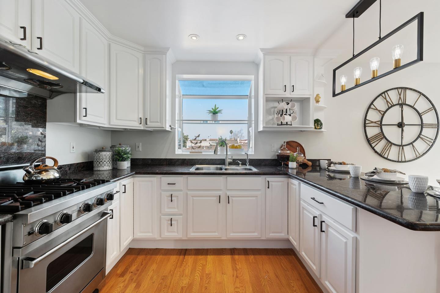 194 Willow Avenue Millbrae, CA 94030 - Photo 19 of 76 a kitchen with granite countertop a sink a stove and cabinets