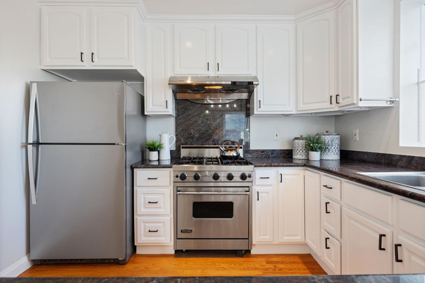 194 Willow Avenue Millbrae, CA 94030 - Photo 22 of 76 a kitchen with cabinets appliances and a counter space